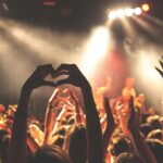 Crowd of fans at a concert with heart hands – representing fandom for Blackpink comeback 2025.